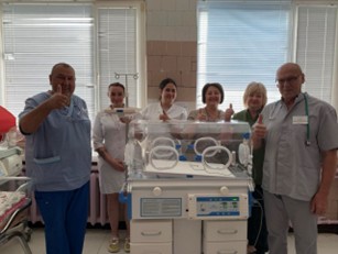 A group of people standing next to an incubatorAI-generated content may be incorrect.