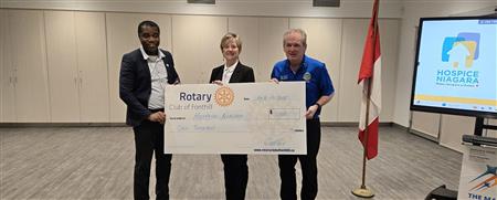 Collins and Hugh present cheque for Hospice to Carol Nagy