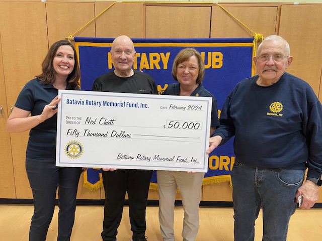 Taking it to the bank … Former Batavian Ned Chatt receives a check for $50,000 as the grand prize winner of the Batavia Rotary Club’s major fundraiser.  Pictured are, from left, Club President Susie Ott, Mr. Chatt, Event Co-Chair Laurie Mastin, and Ed Leising from the Club’s Foundation Board.  