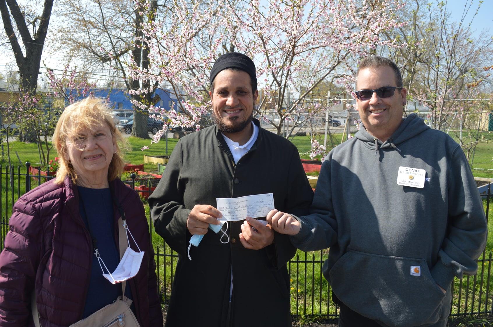 Barb and Denis presenting a check for medical equipment (Muslim Wellness Center)