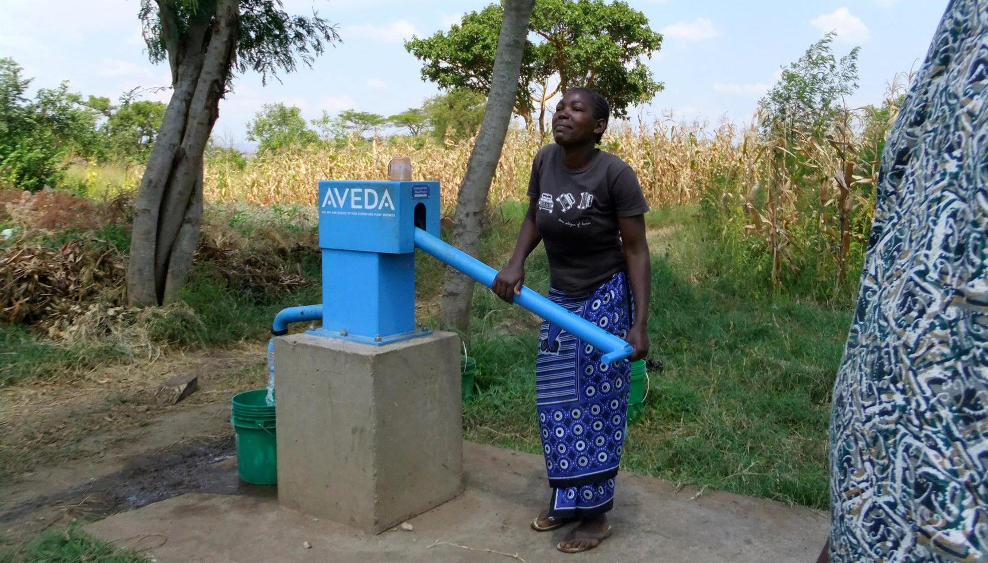 Woman in Tanzania using a Global Grant water well