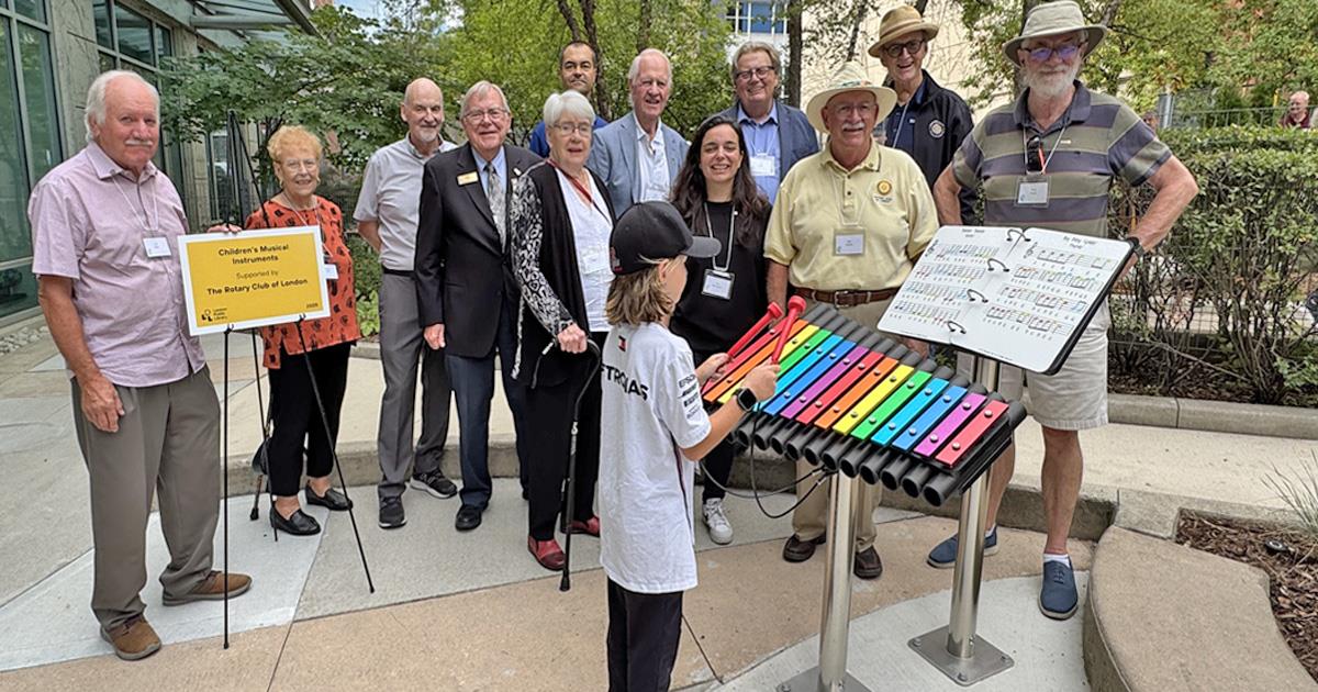 A young musician plays Xylophone at upgraded Rotary Reading Garden. 