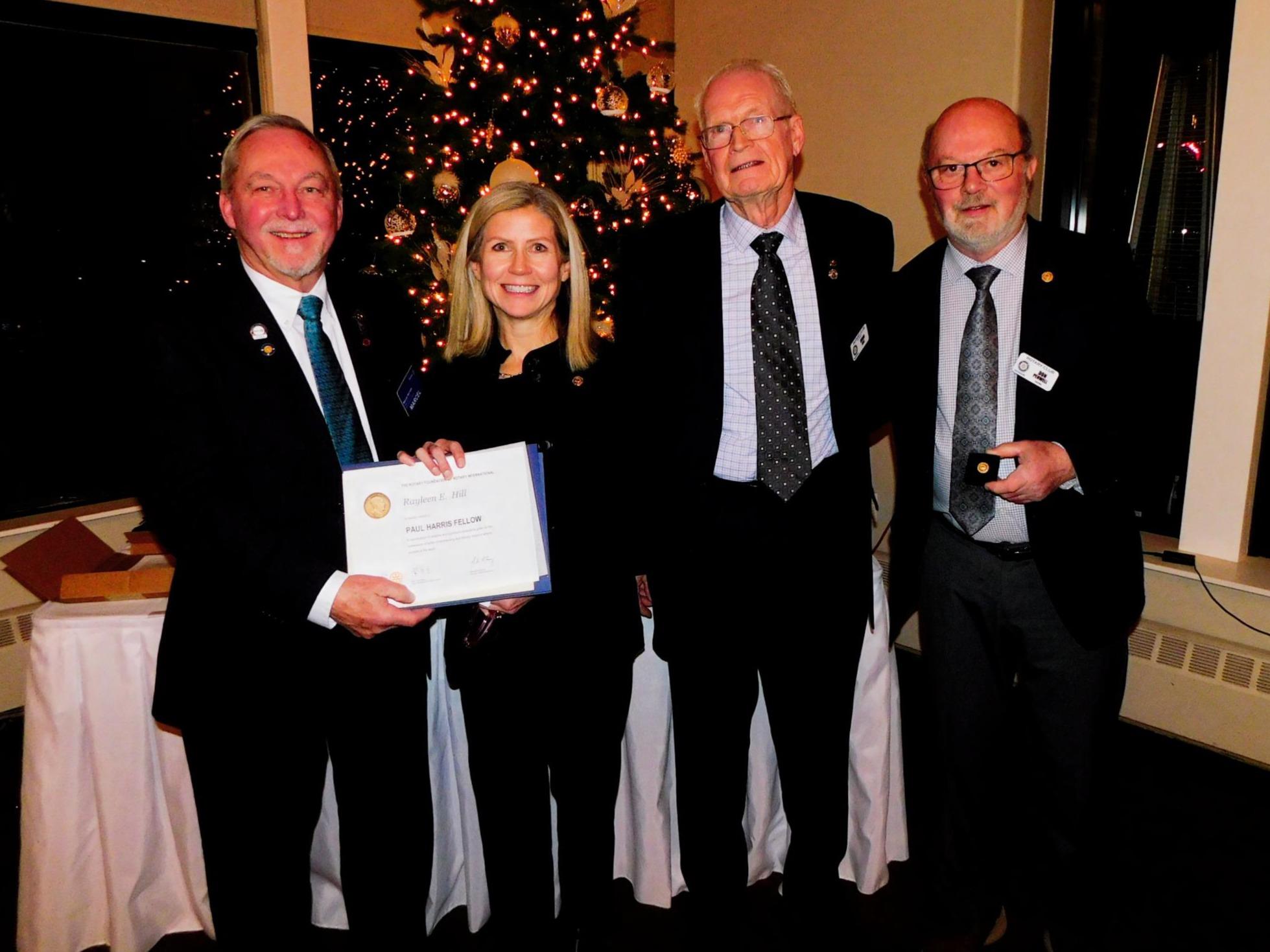 Left to right: Rotary District North Atlantic Governor Marcel Gervais, Paul Harris Fellow Rayleen Hill, Doug Hill and Don Penwell