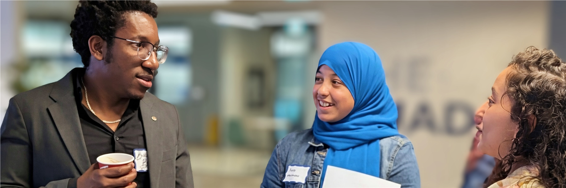 RCWO Member Bachir Bastien talks with participants at Adventure in Finance, 2025