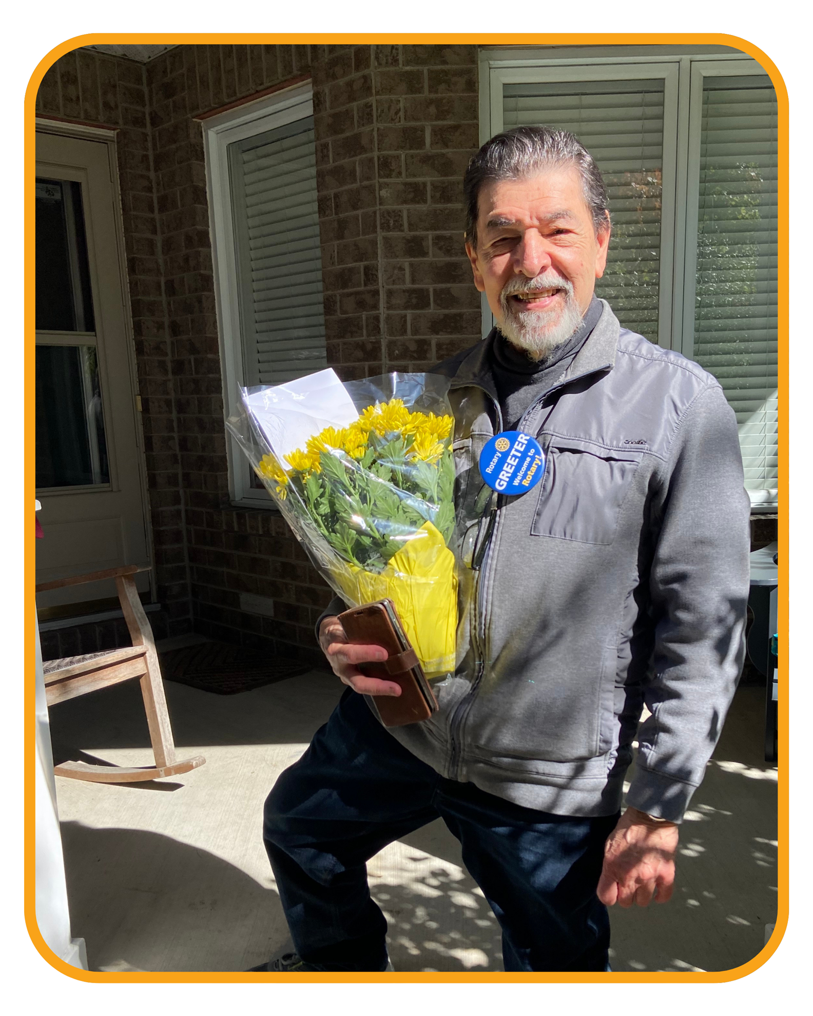 A Rotary volunteer delivering Thanksgiving mums.