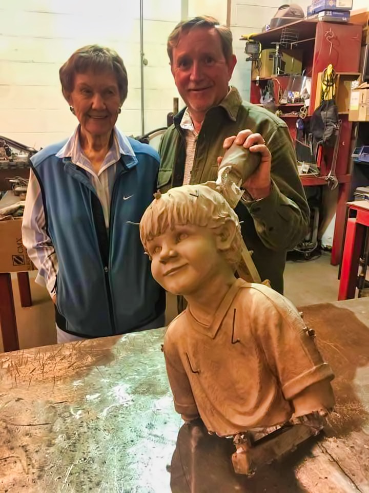 Ardis Morrow and Jeff Oens with the statue
