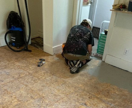 Winnipeg West Rotarian Kelly finshes tear out and levels floor