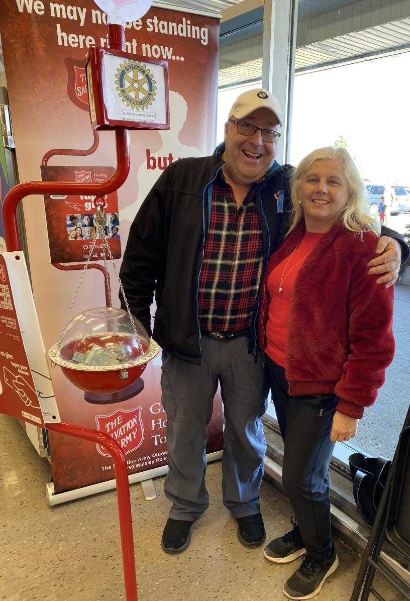 Jeff Sirrs and Rosemary Parker of the Rotary Club Ottawa South stand beside the Salvation Army Christmas kettle.