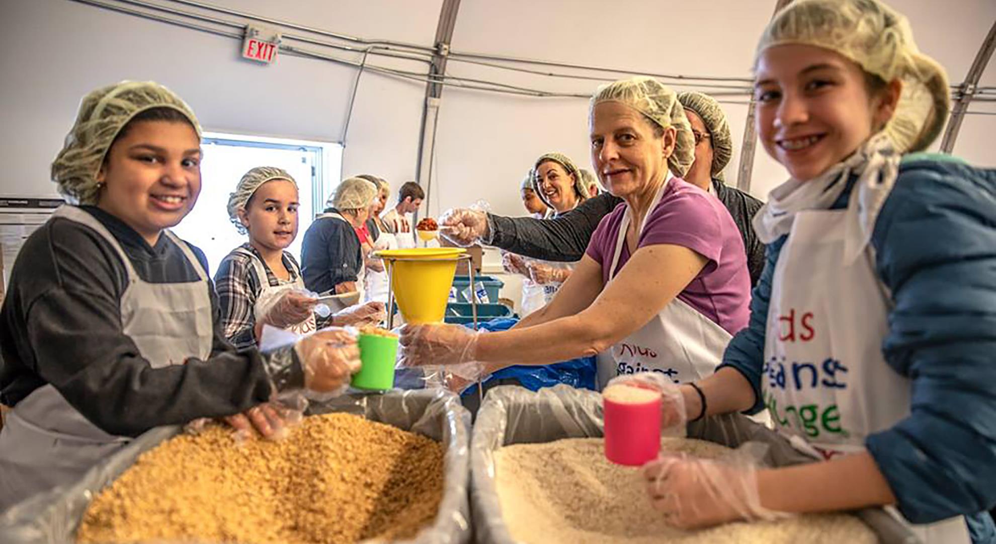 Our Rotary Families Packing Meals - Kids Against Hunger 