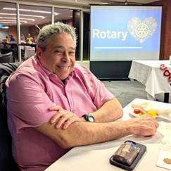 A person sitting at a tableDescription automatically generated