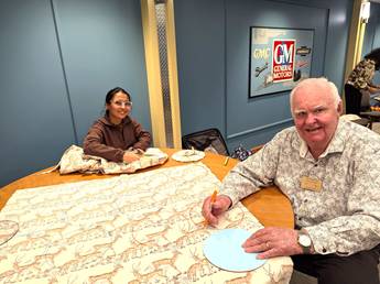 A person and person sitting at a tableDescription automatically generated