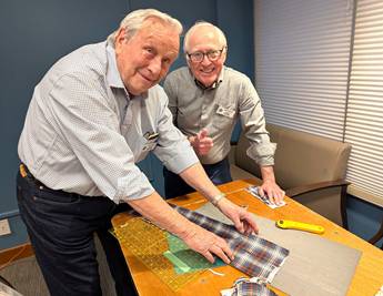 A couple of men working on fabricDescription automatically generated