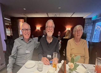 A group of people sitting at a tableDescription automatically generated