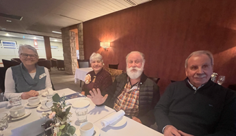 A group of people sitting at a tableDescription automatically generated