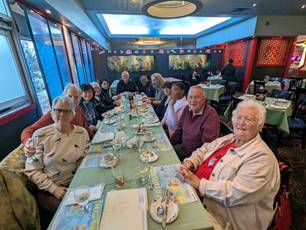 A group of people sitting at a tableDescription automatically generated