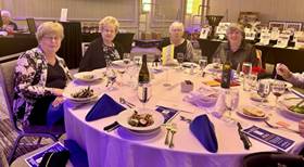 A group of women sitting at a tableDescription automatically generated