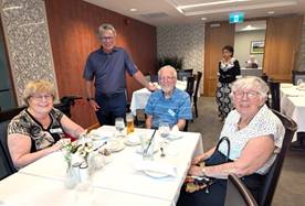 A group of people sitting at a tableDescription automatically generated
