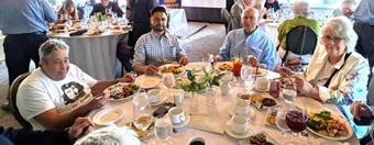 A group of people sitting at a tableDescription automatically generated