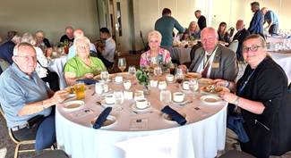 A group of people sitting at a tableDescription automatically generated