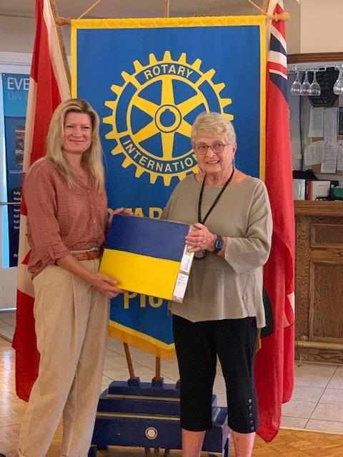 President Barb Proctor presents Iryna Nesterets with a laptop to help her family apply for Canadian documents and learn English