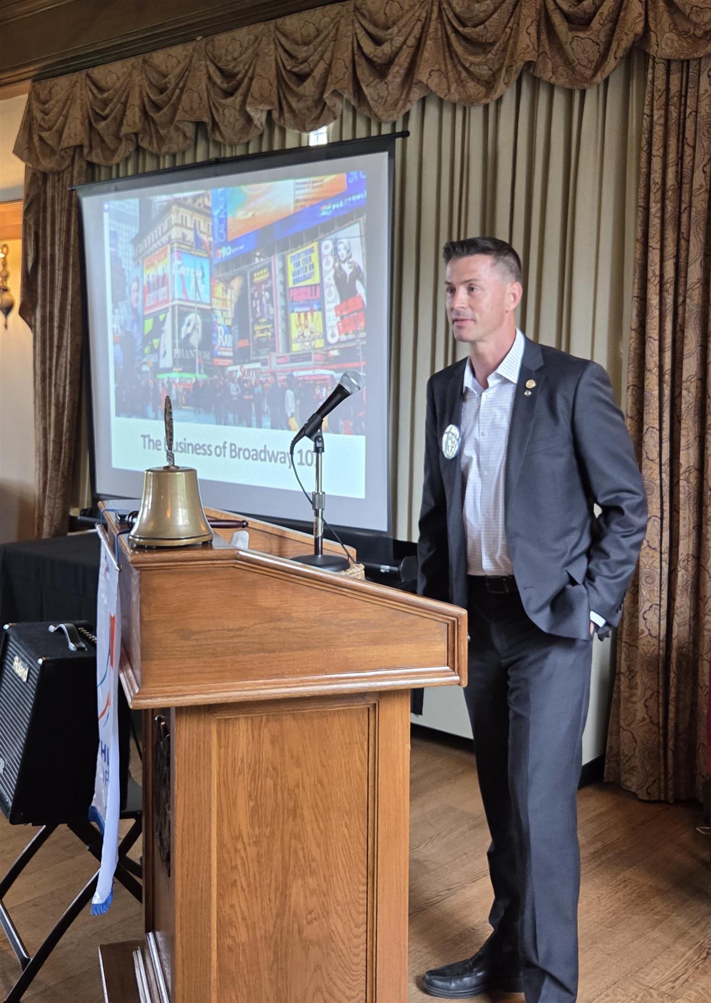 A person standing in front of a podiumAI-generated content may be incorrect.