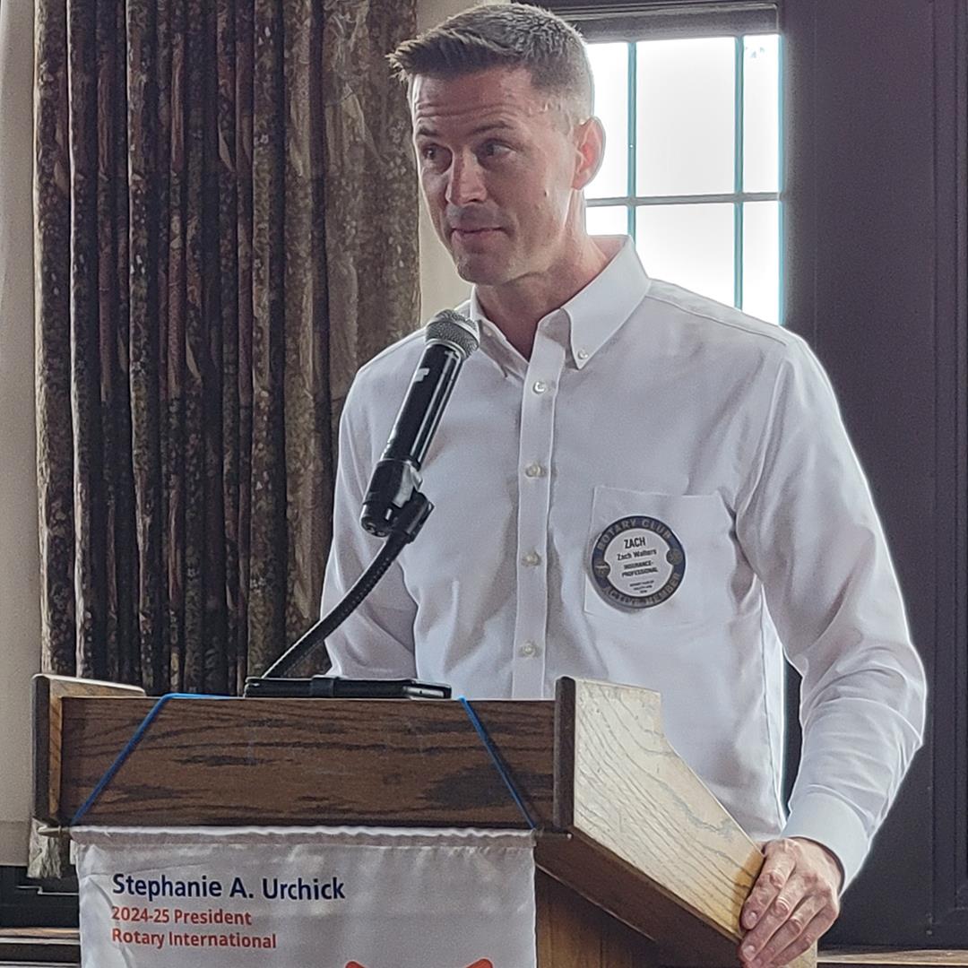 A person standing at a podiumAI-generated content may be incorrect.