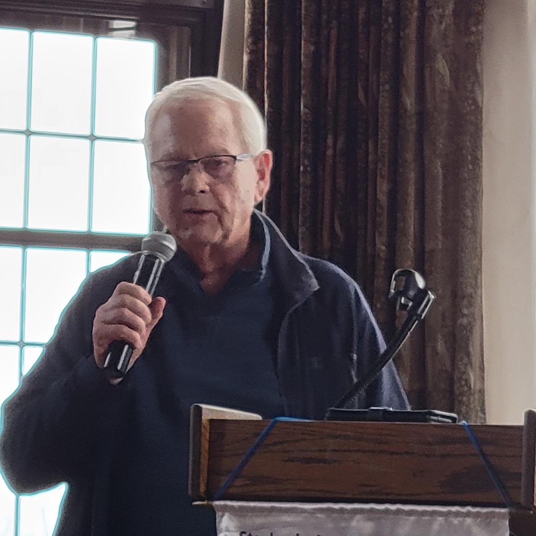 A person speaking into a microphoneAI-generated content may be incorrect.