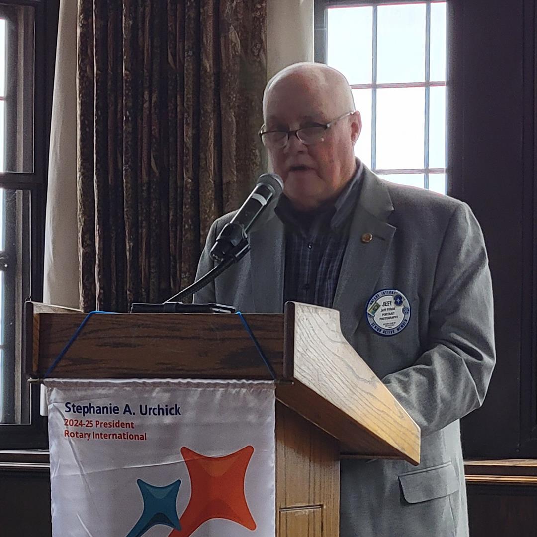 A person standing at a podiumAI-generated content may be incorrect.