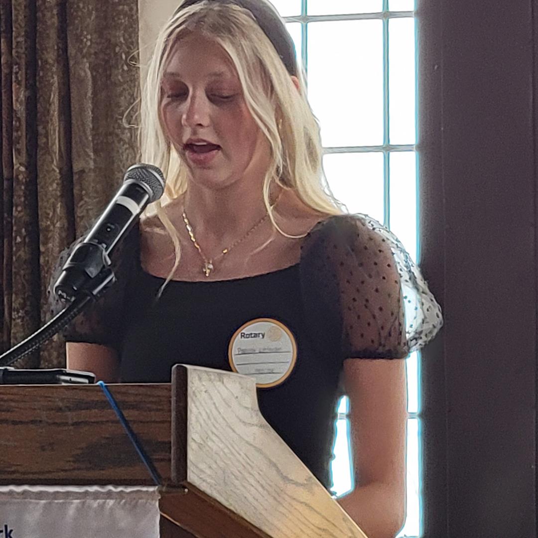 A person standing at a podiumAI-generated content may be incorrect.