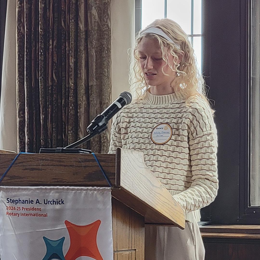 A person standing at a podiumAI-generated content may be incorrect.