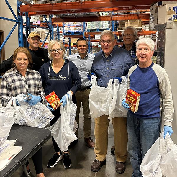A group of people in a warehouseDescription automatically generated