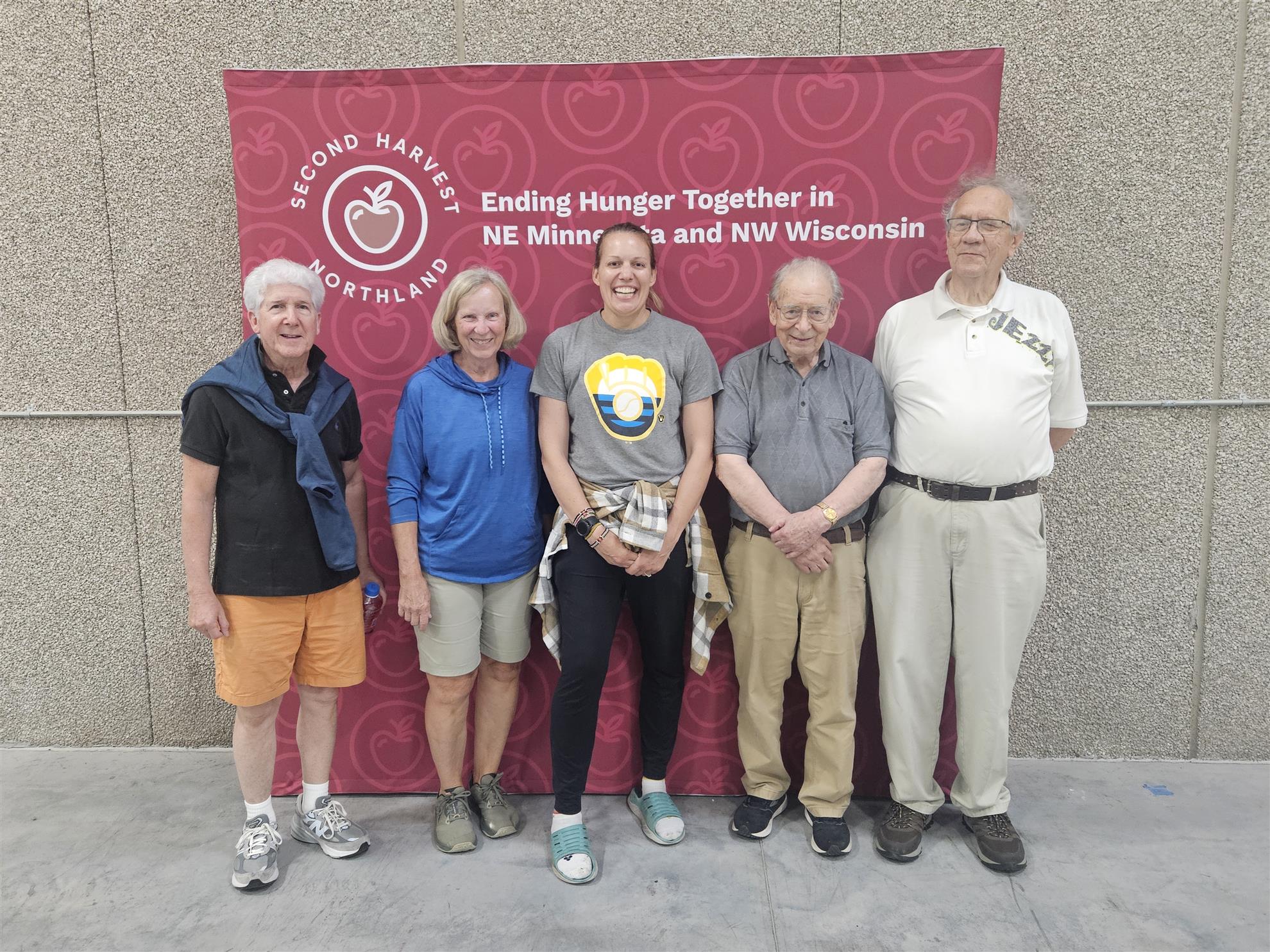 A group of people standing in front of a bannerAI-generated content may be incorrect.