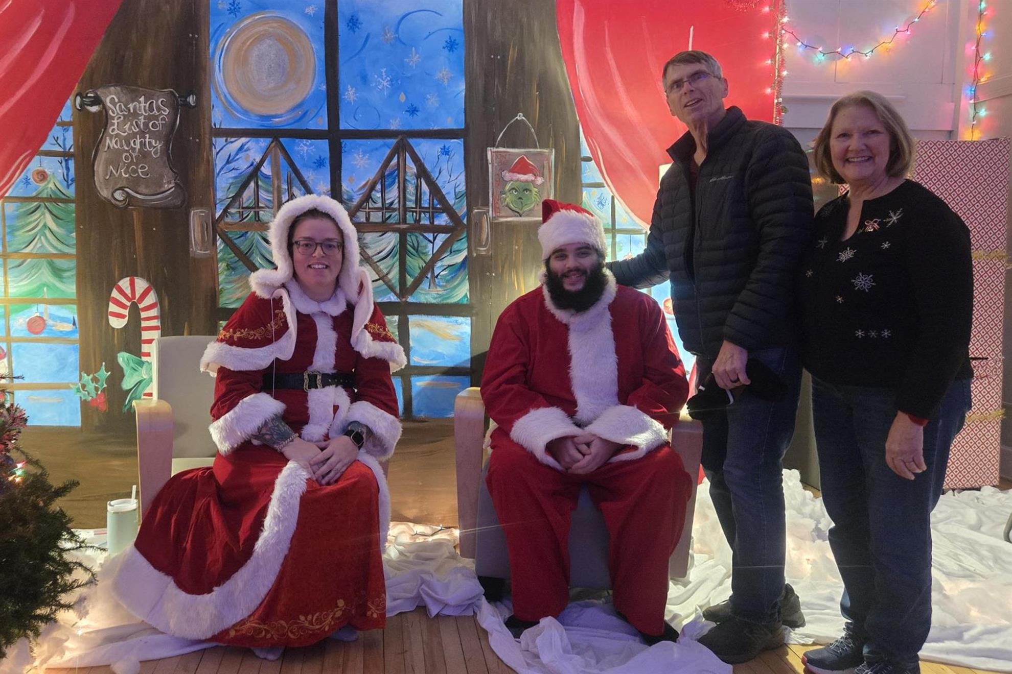 A person and person standing in front of a decorated fireplaceDescription automatically generated