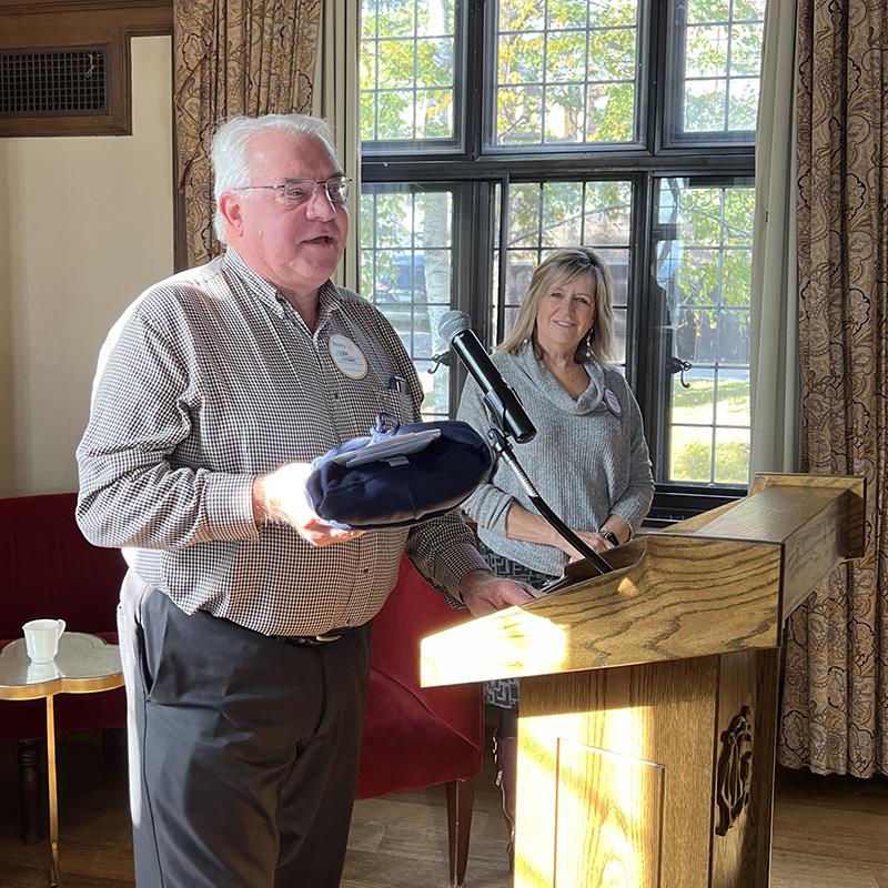 A person standing at a podium with a microphoneDescription automatically generated