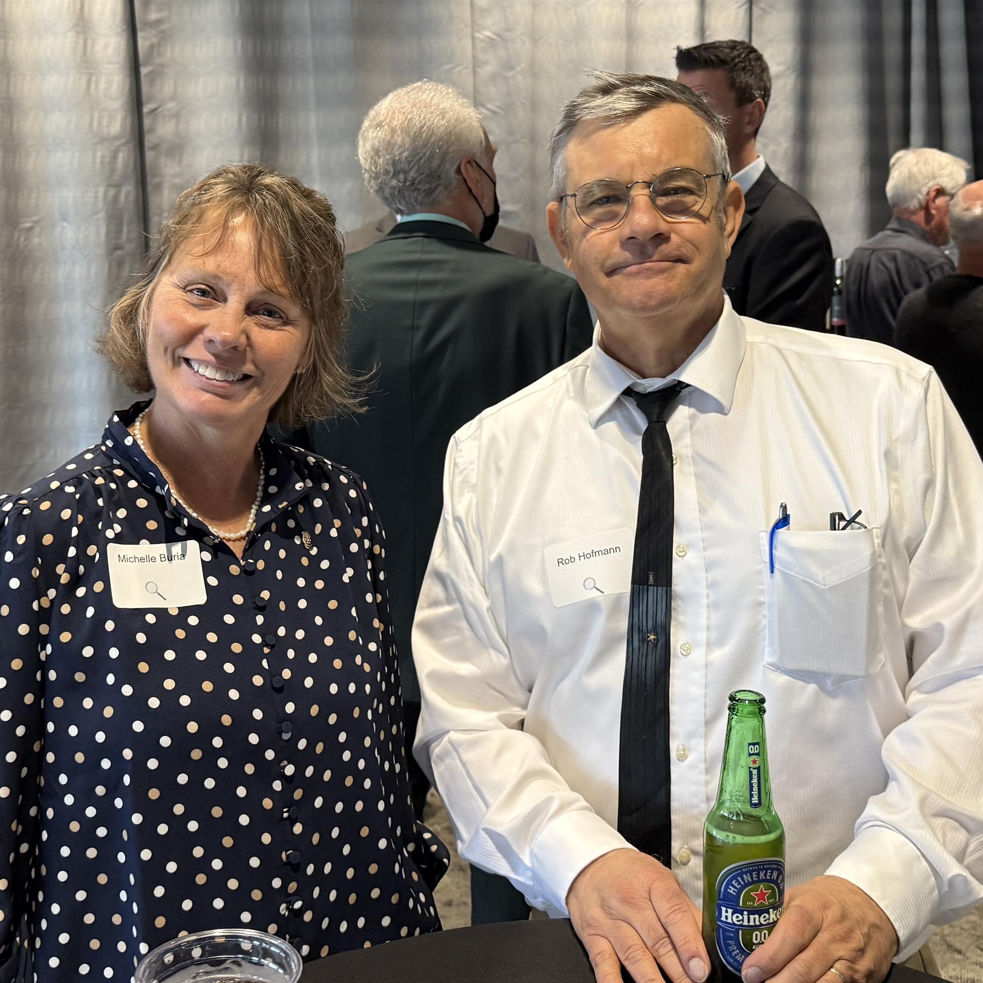 A person and person standing next to each otherAI-generated content may be incorrect.