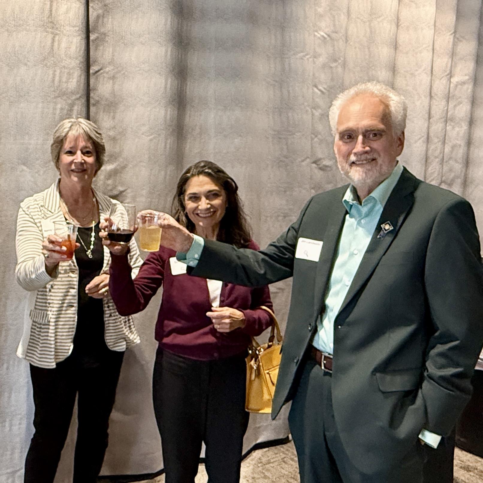 A group of people holding drinksAI-generated content may be incorrect.