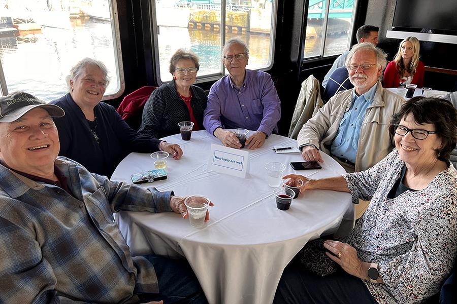 A group of people sitting around a tableDescription automatically generated