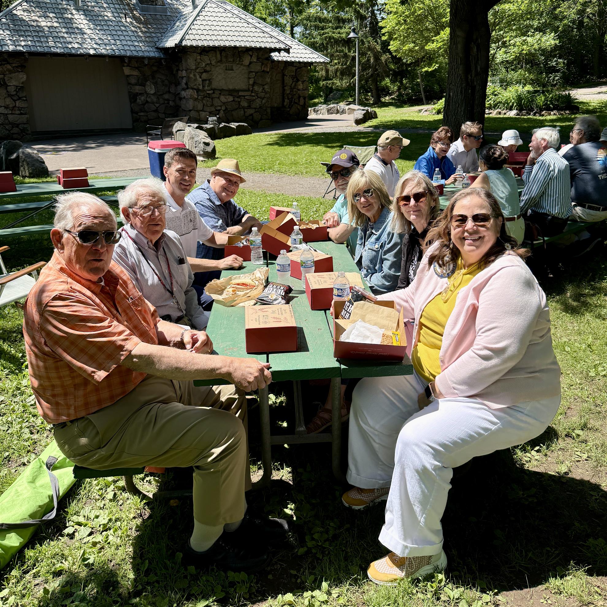 A group of people sitting at a tableAI-generated content may be incorrect.
