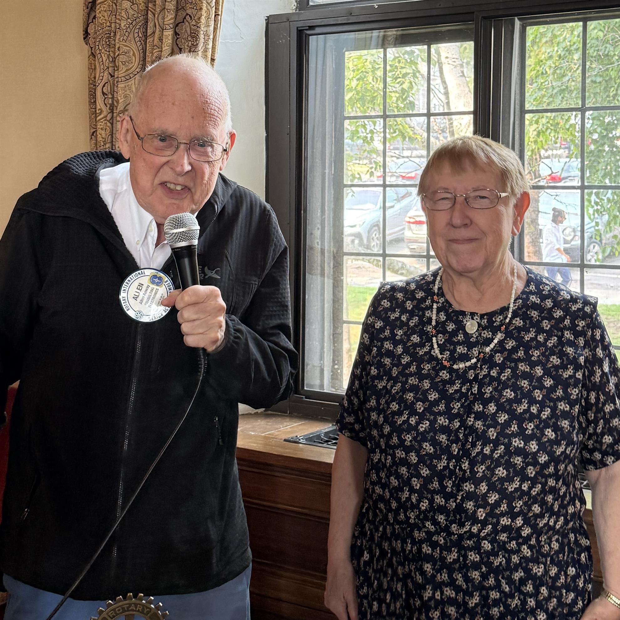 A person holding a microphone next to a personAI-generated content may be incorrect.