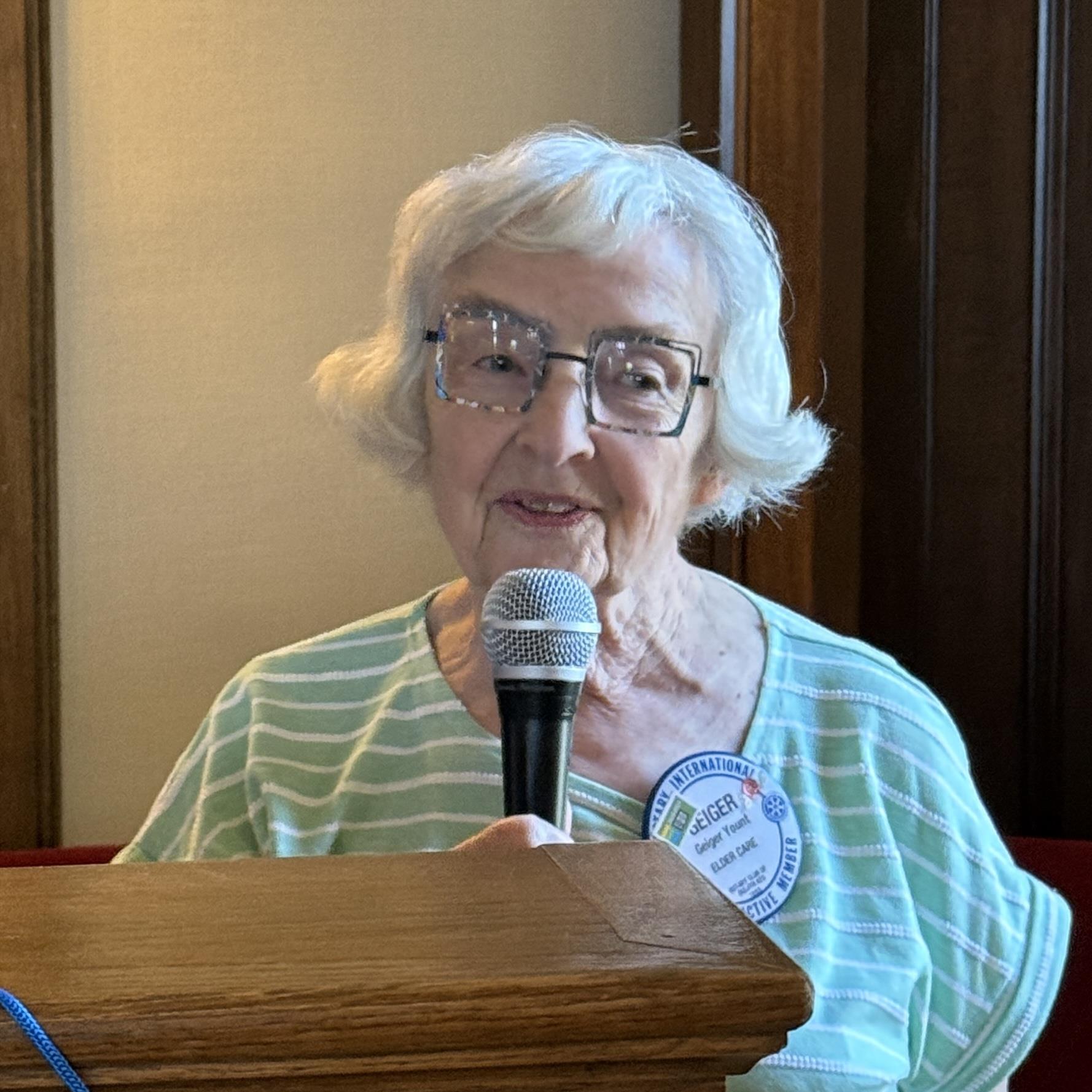 A person holding a microphoneAI-generated content may be incorrect.