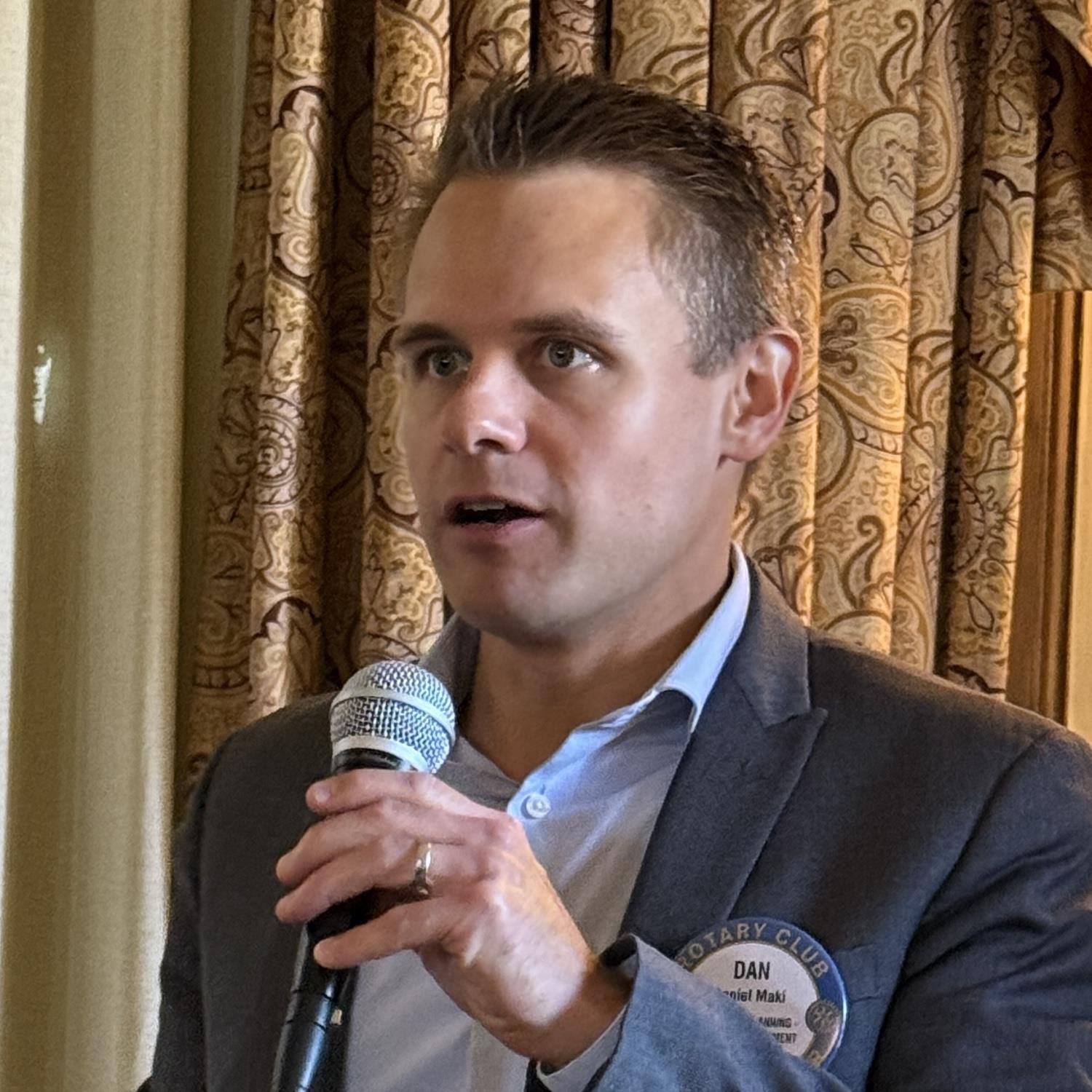 A person holding a microphoneAI-generated content may be incorrect.