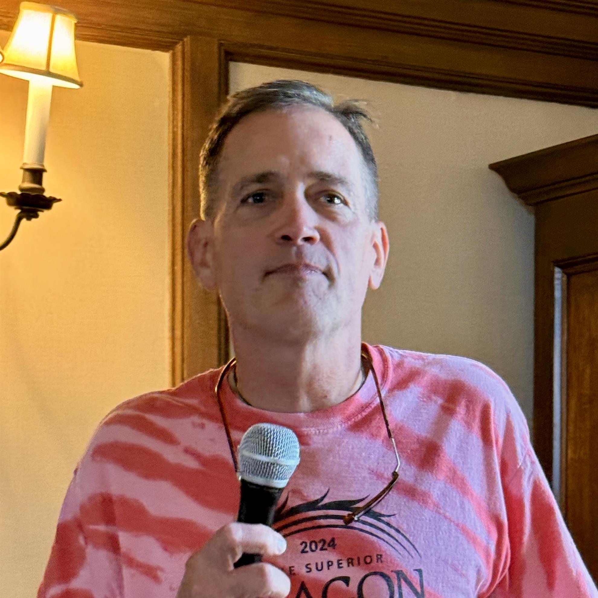 A person holding a microphoneAI-generated content may be incorrect.