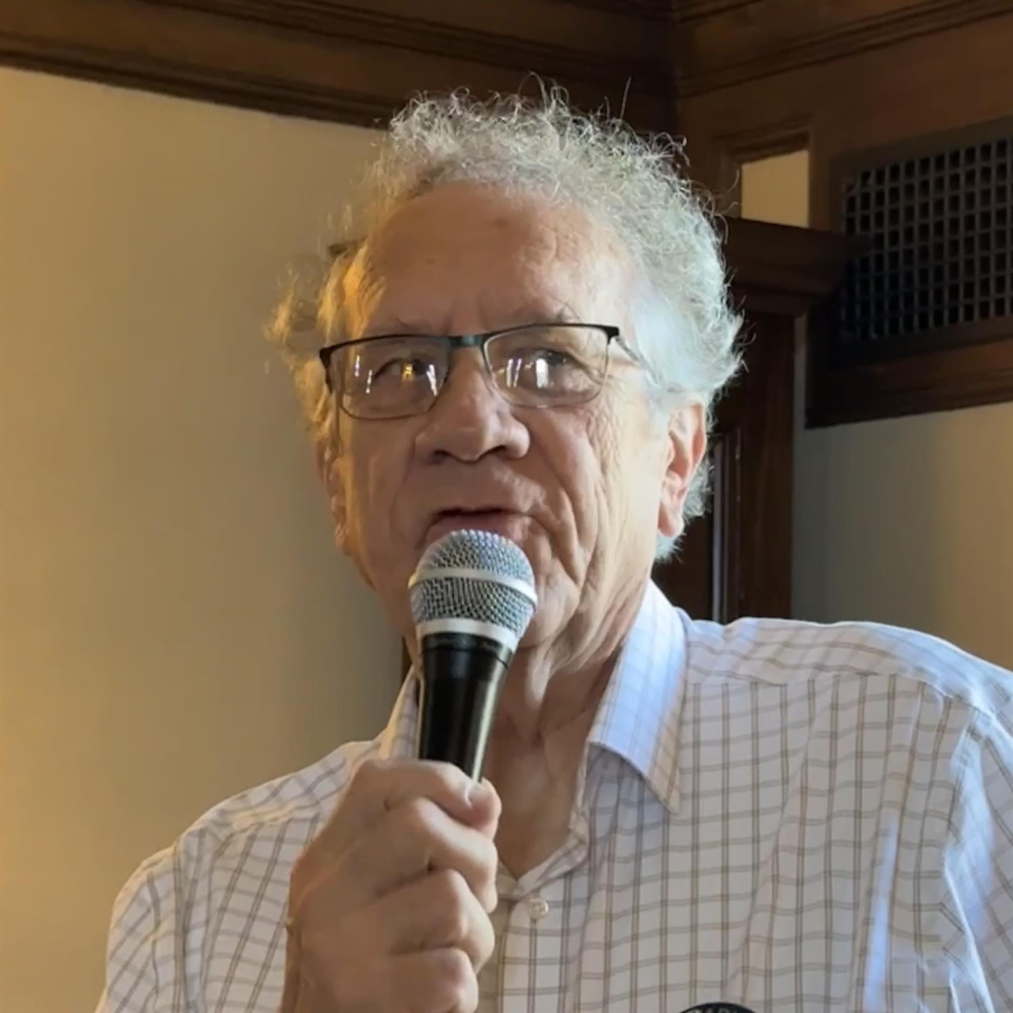 A person holding a microphoneAI-generated content may be incorrect.