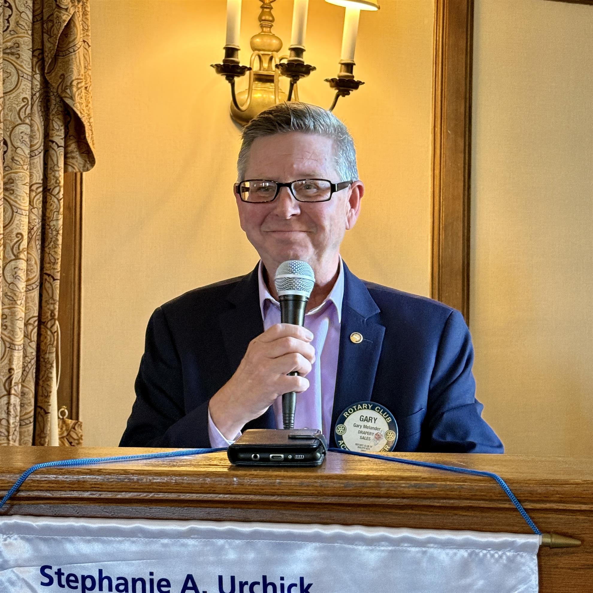 A person holding a microphoneAI-generated content may be incorrect.