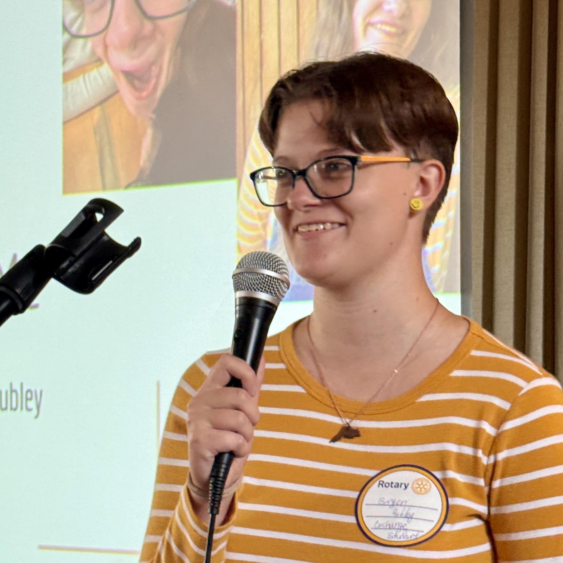 A person holding a microphoneAI-generated content may be incorrect.