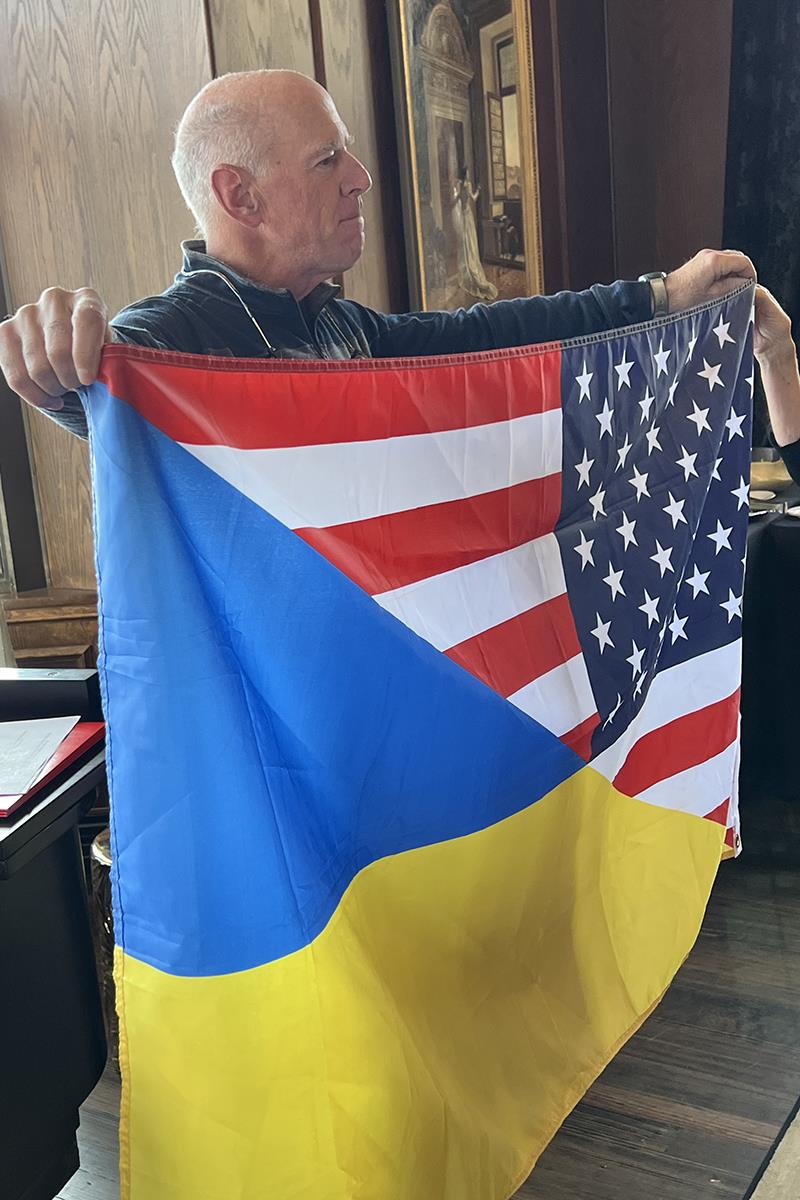 A person holding a flagDescription automatically generated