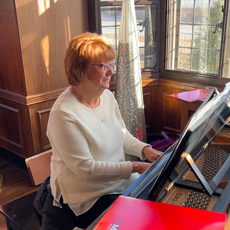 A person playing a pianoDescription automatically generated