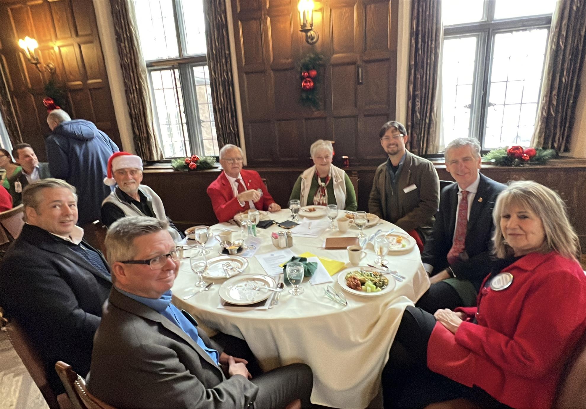 A group of people around a round tableDescription automatically generated