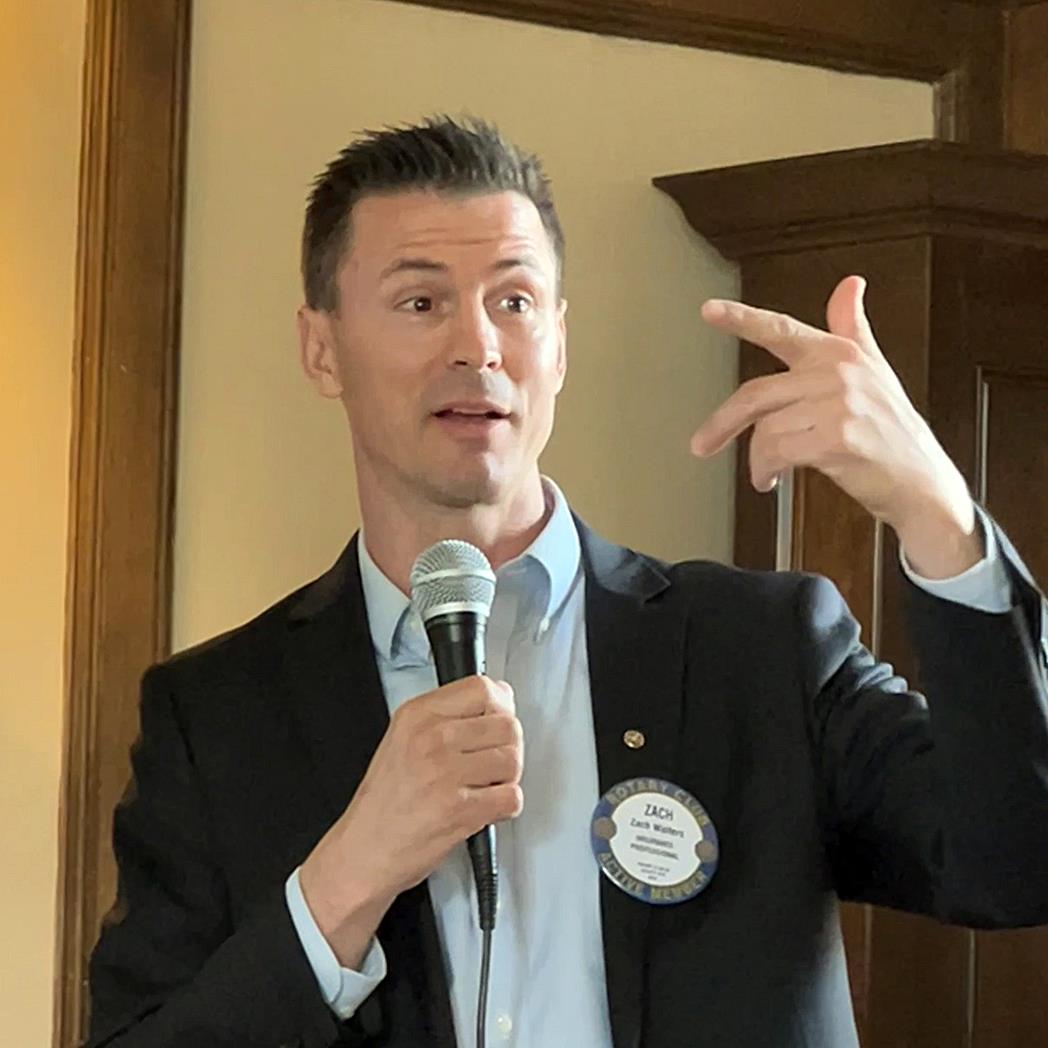 A person holding a microphone and pointing at somethingAI-generated content may be incorrect.