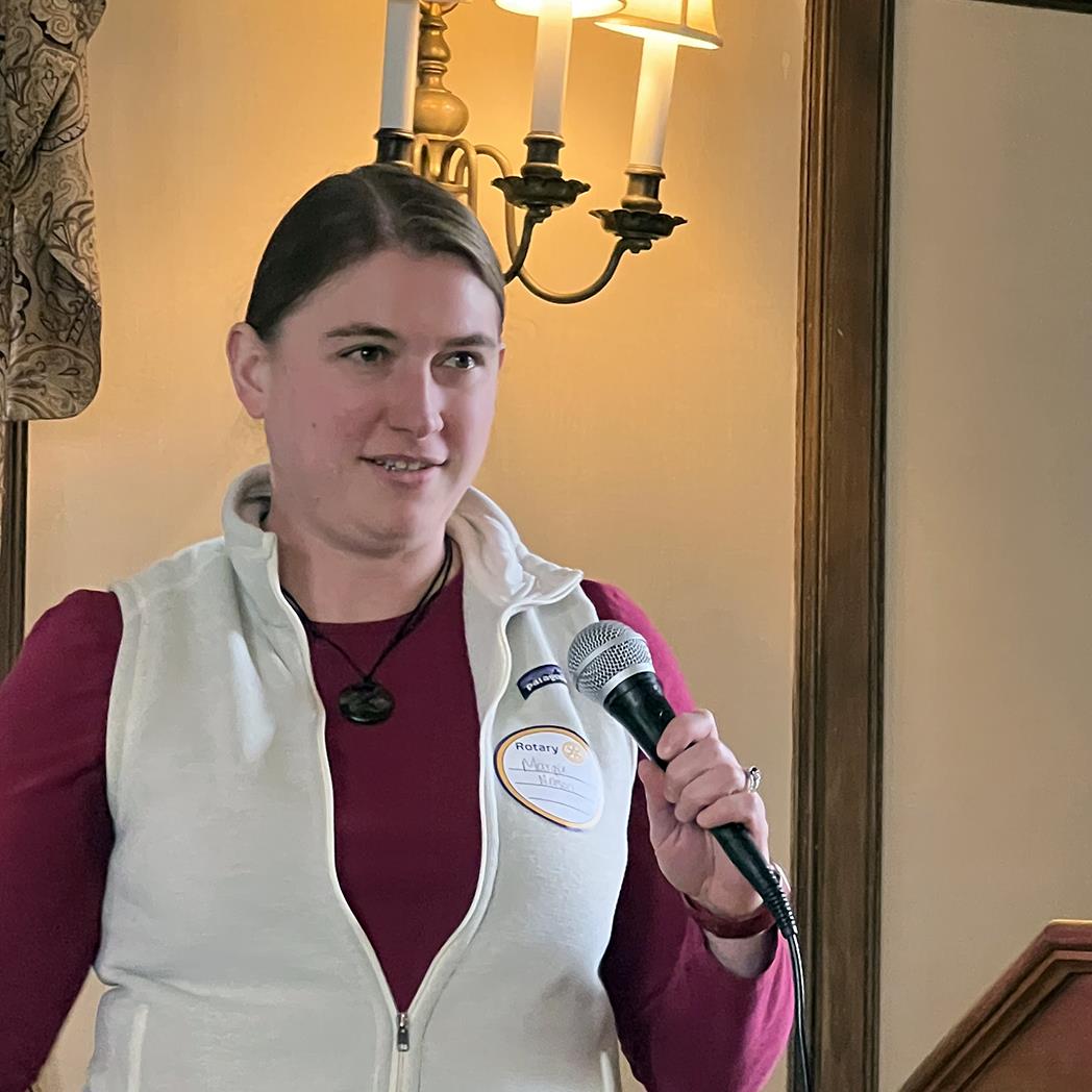 A person holding a microphoneAI-generated content may be incorrect.